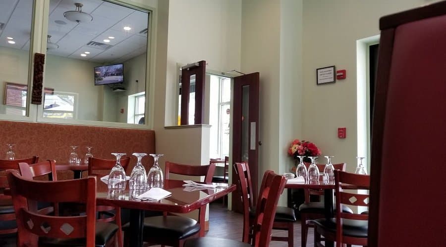 The dining room — set tables with wine glasses, warm lighting