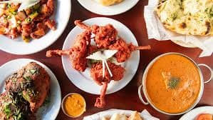 A tandoori chicken and curry spread photographed from above